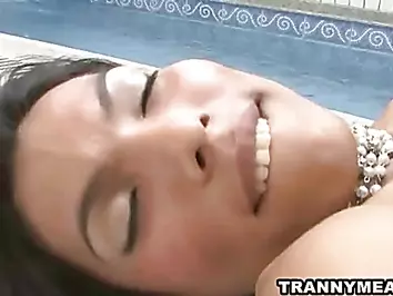 A sexy tranny by the pool is jerking herself off